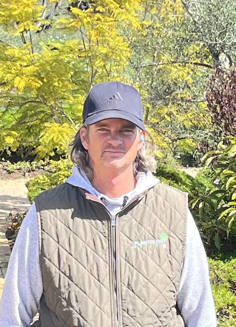 Plantology crew member in a company vest