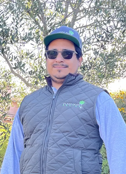 Plantology crew member in a company vest